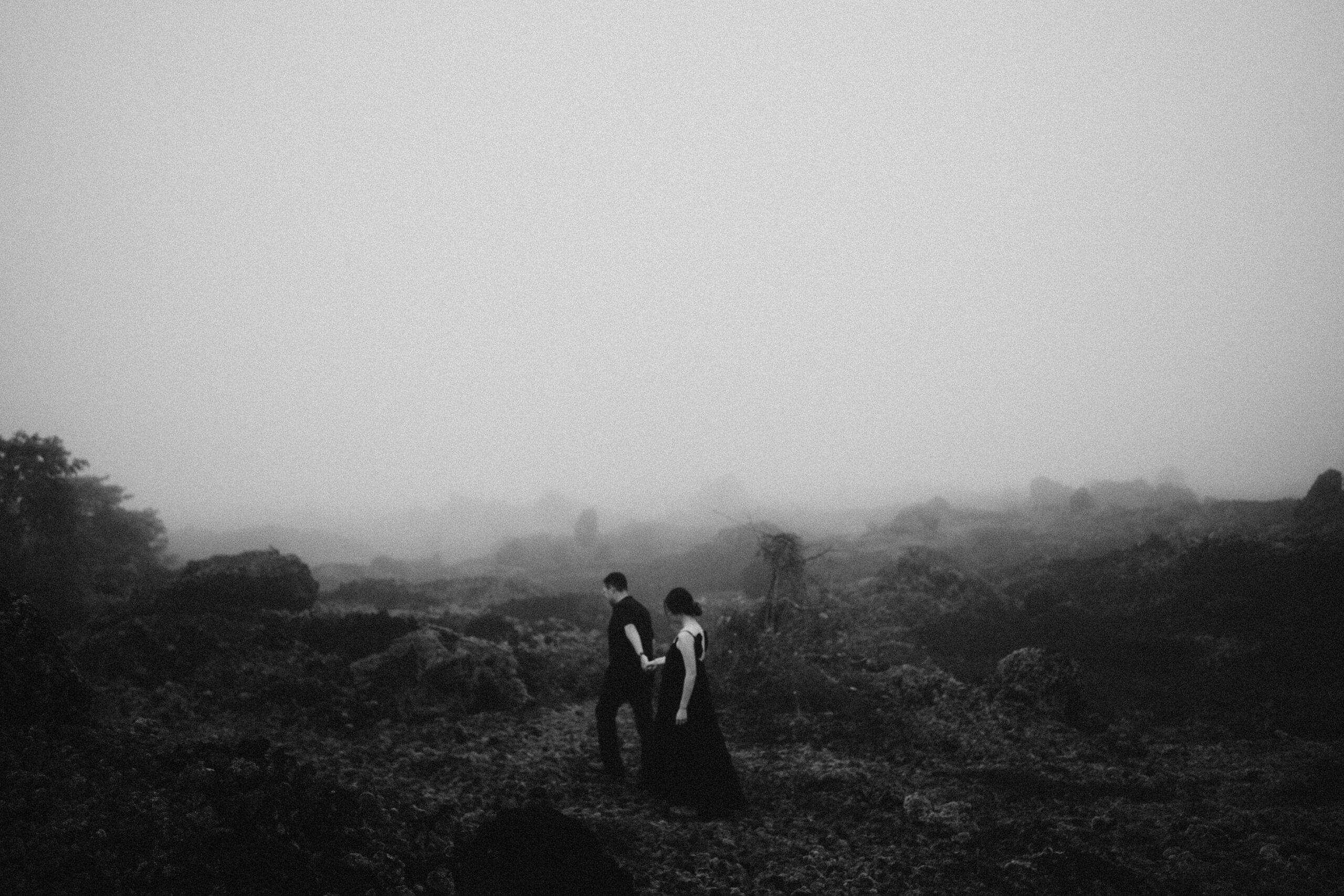 Bride holding Groom hand walking in mountains